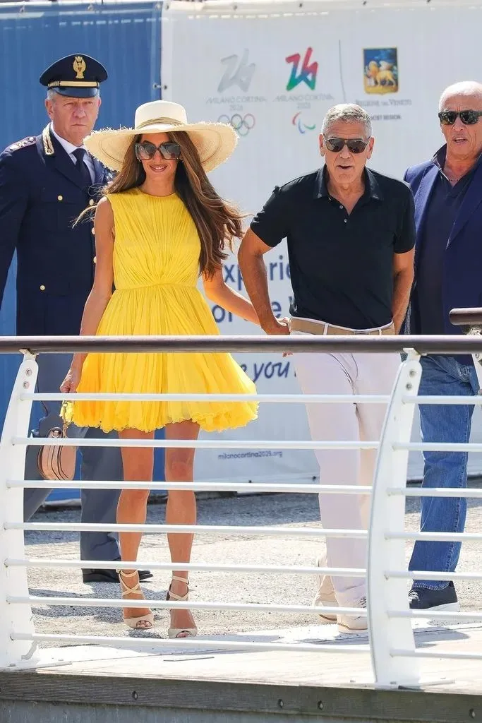 Amal Clooney dazzles in a mini dress while appearing with husband George.