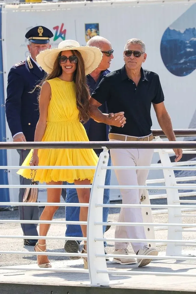 Amal Clooney dazzles in a mini dress while appearing with husband George.