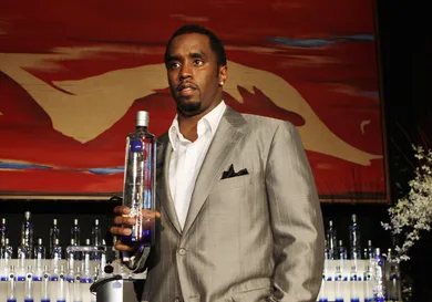 Sean "Diddy" Combs holds a bottle of Cir