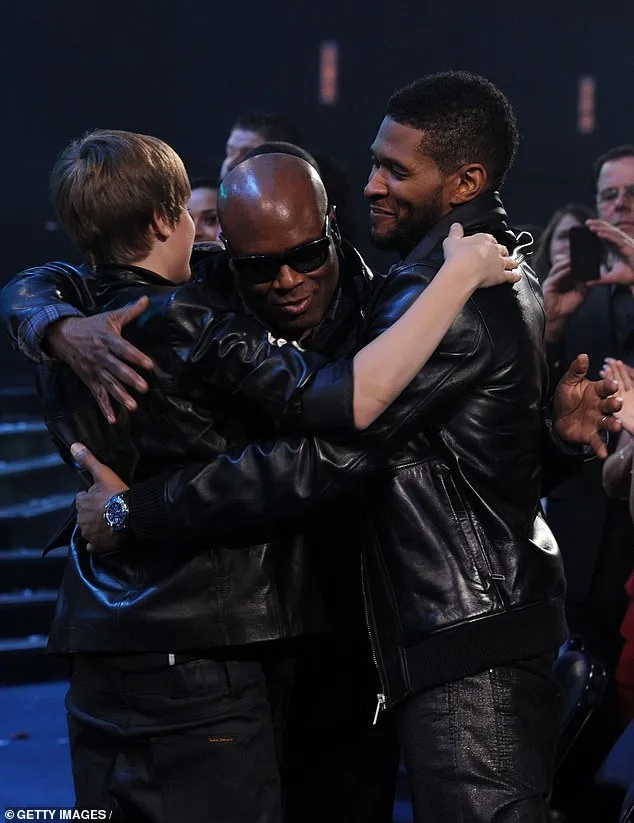 Usher (right) brought Justin Bieber (left) to music mogul L.A Reid (middle) as a 'gift' when he was a 'beautiful' 14-year-old boy