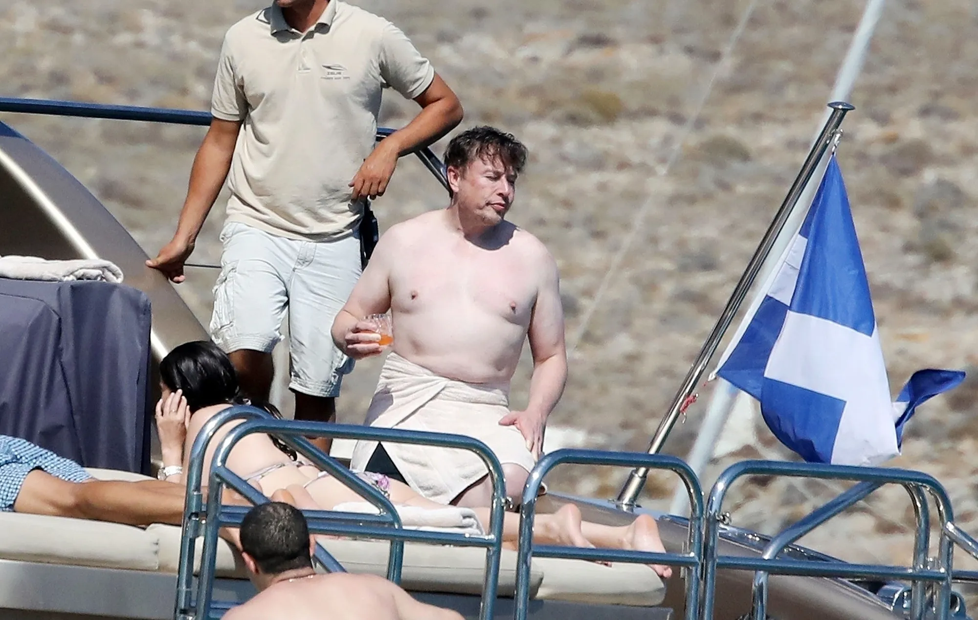 Shirtless Elon Musk on a luxury yacht