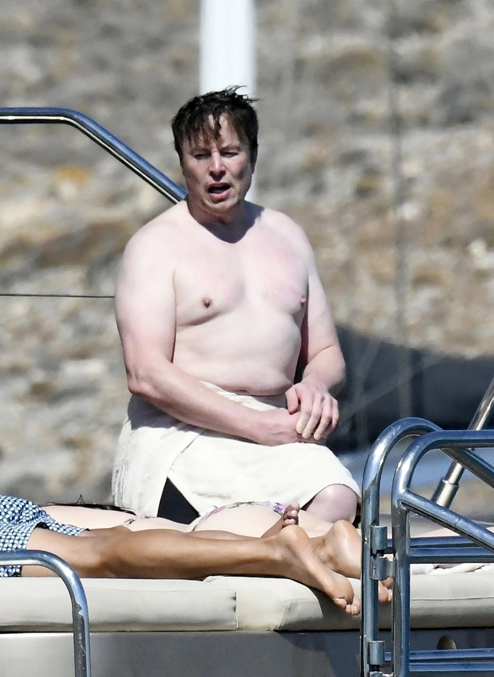 Shirtless Elon Musk on a luxury yacht