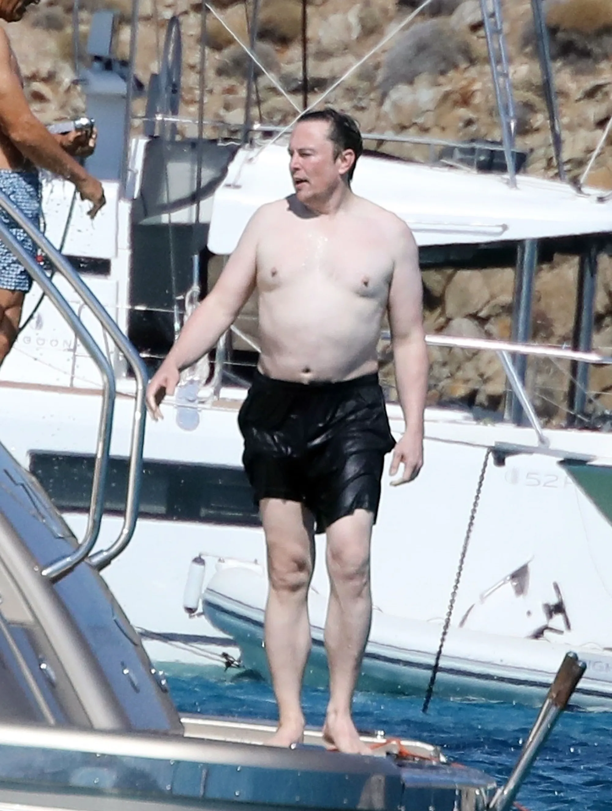 Shirtless Elon Musk on a luxury yacht