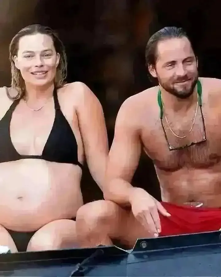 Margot Robbie showcasing her baby bump while on vacation in Italy last year with her husband Tom Ackerley..... 1 Margot Robbie showcasing her baby bump while on vacation in Italy last year with her husband Tom Ackerley.....